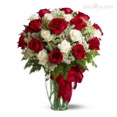 Two dozen red and white roses in a glass vase