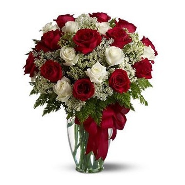 Two dozen red and white roses in a glass vase
