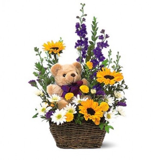 basket of spring flowers and a teddy bear