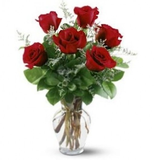 Arrangement of six roses in a glass vase